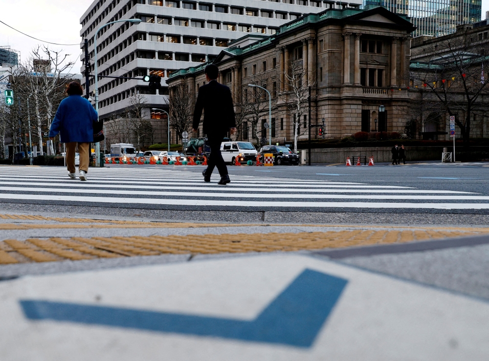 People walk in front of the Bank of Japan building in Tokyo January 23, 2024. — Reuters pic  