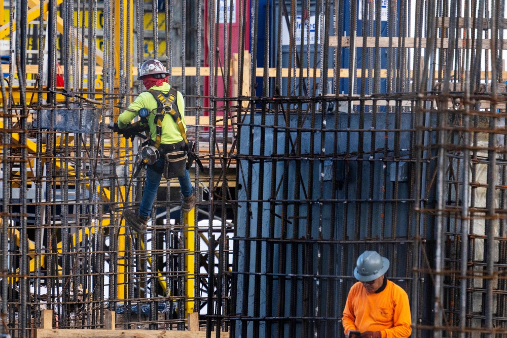 Construction workers erect a building in downtown Miami, Florida June 14, 2023. Hiring in the US stayed robust in February while unemployment crept up, US Department of Labour data showed on March 8, 2024. — AFP pic 