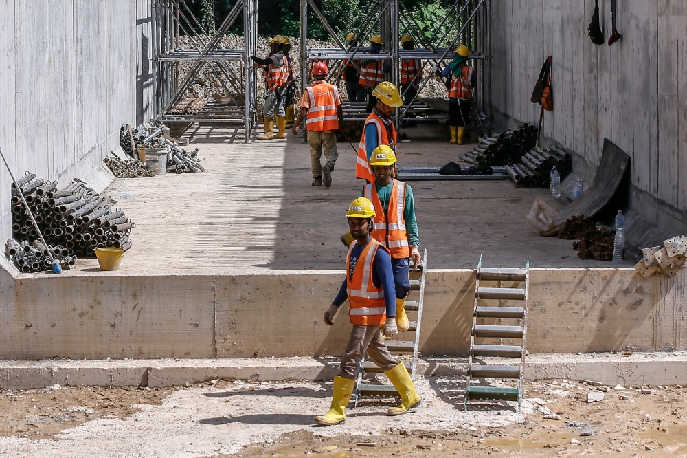 File picture of construction workers for the East Coast Rail Link (ECRL) project at the Kemasul reserve forest in Pahang, March 6, 2023. Home Minister Datuk Seri Saifuddin Nasution Ismail announced last Friday that all active recruitment quota for workers from Bangladesh will be voided if firms fail to have their calling visas ready by March 1, in a move that caught industries by surprise. — Picture by Hari Anggara