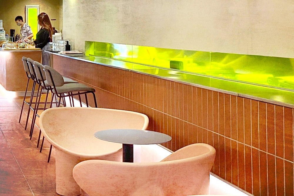 A gently lit, salmon-hued interior with lime-green accents.