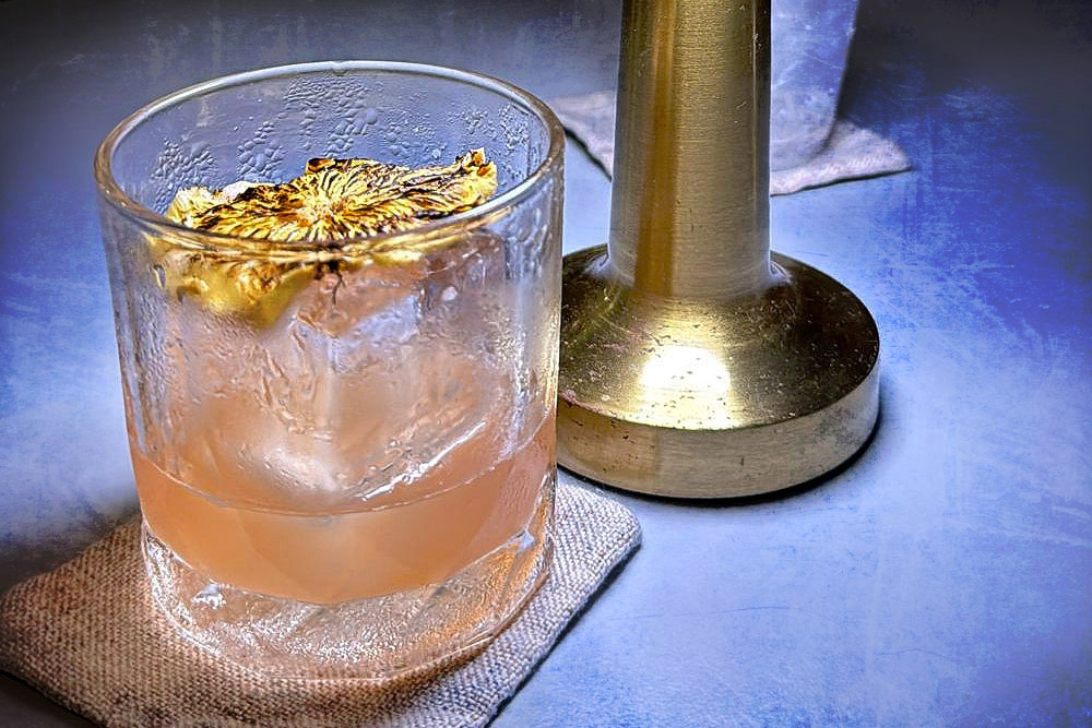 Conti’s Junglebird features aged rum, Campari and lime, topped with a slice of hand-torched dehydrated pineapple.