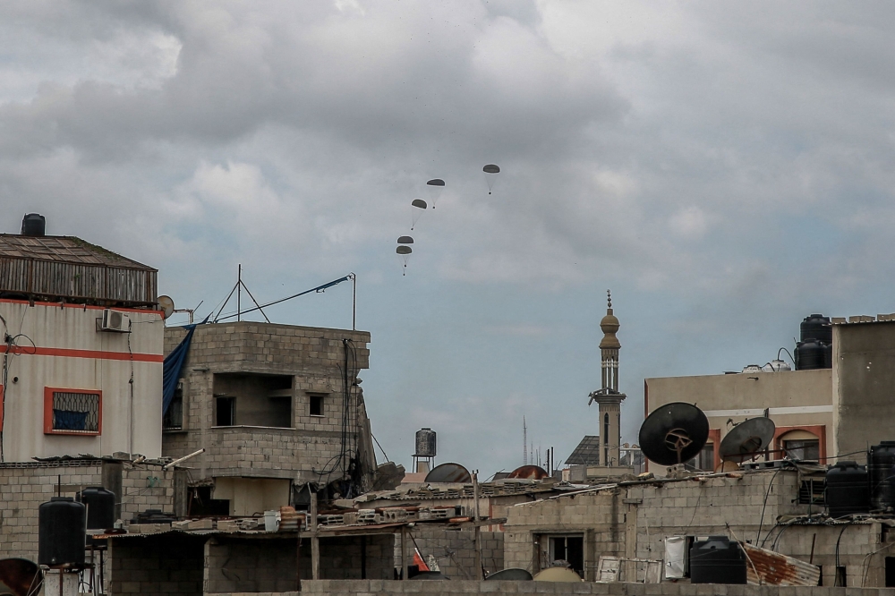 Aid parcels are airdropped over the northern Gaza Strip on March 8, 2024, amid the ongoing conflict between Israel and the Hamas movement. ― AFP pic