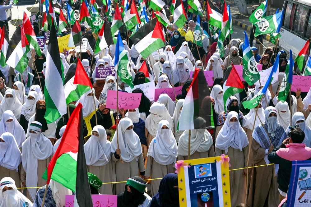 Jamaat-e-Islami (JI) party activists demonstrate in support of Palestinian women on the occasion of International Women's Day, in Lahore on March 8, 2024. — AFP pic