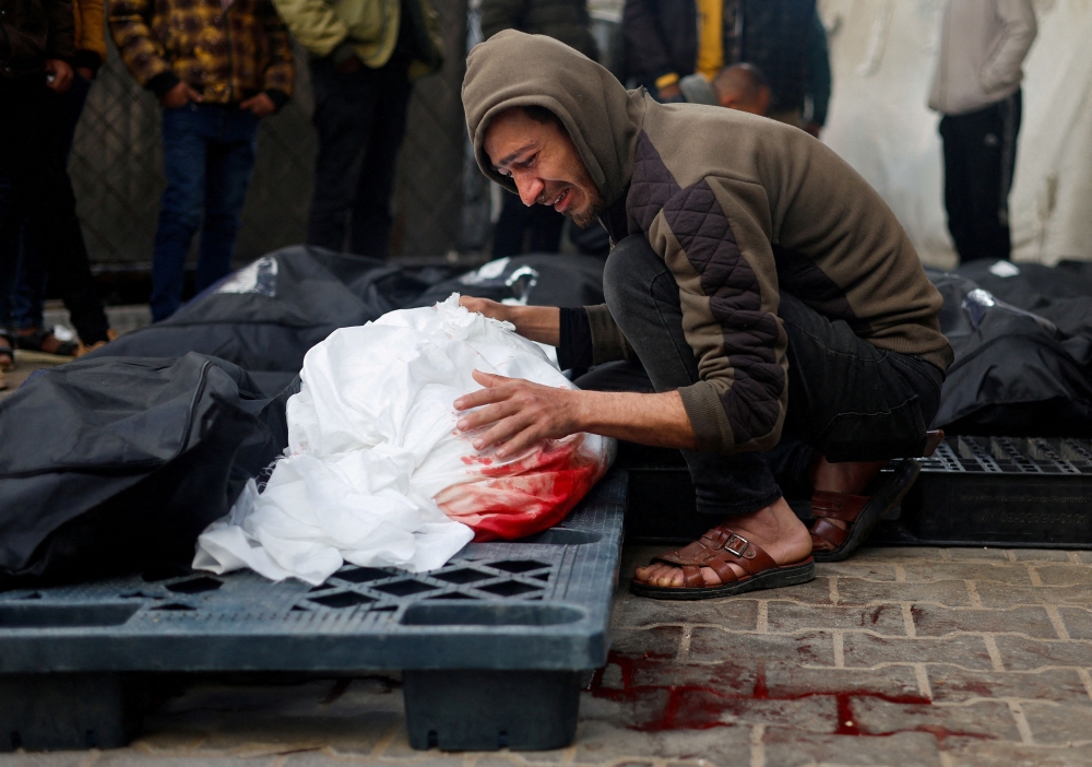 A Palestinian man mourns the loos of a loved one. — Reuters pic