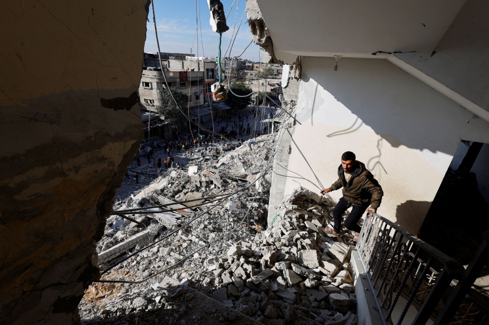 A Palestinian man walks through the rubble of a building damaged in an Israeli air strike, amid the ongoing conflict between Israel and the Palestinian Islamist group Hamas, in Rafah, in the southern Gaza Strip March 9, 2024. — Reuters pic