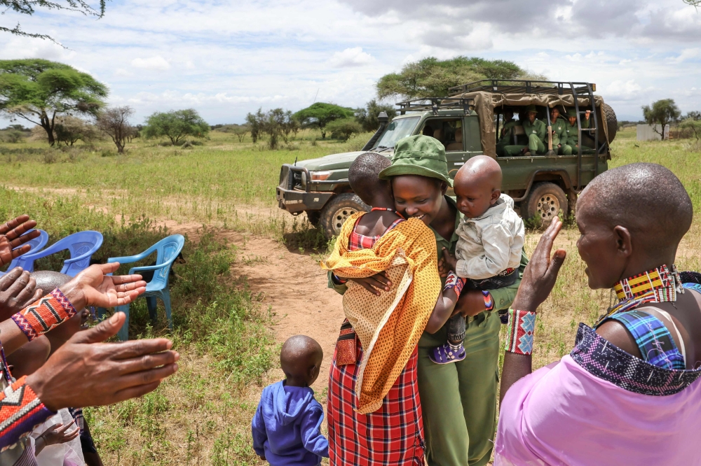 Sharon Mumbi, 21, a member of Team Lioness is greeted by relatives as she arrives at her parents' home for the start of her sabbatical in Endoinyoenkai on February 29, 2024. — AFP pic