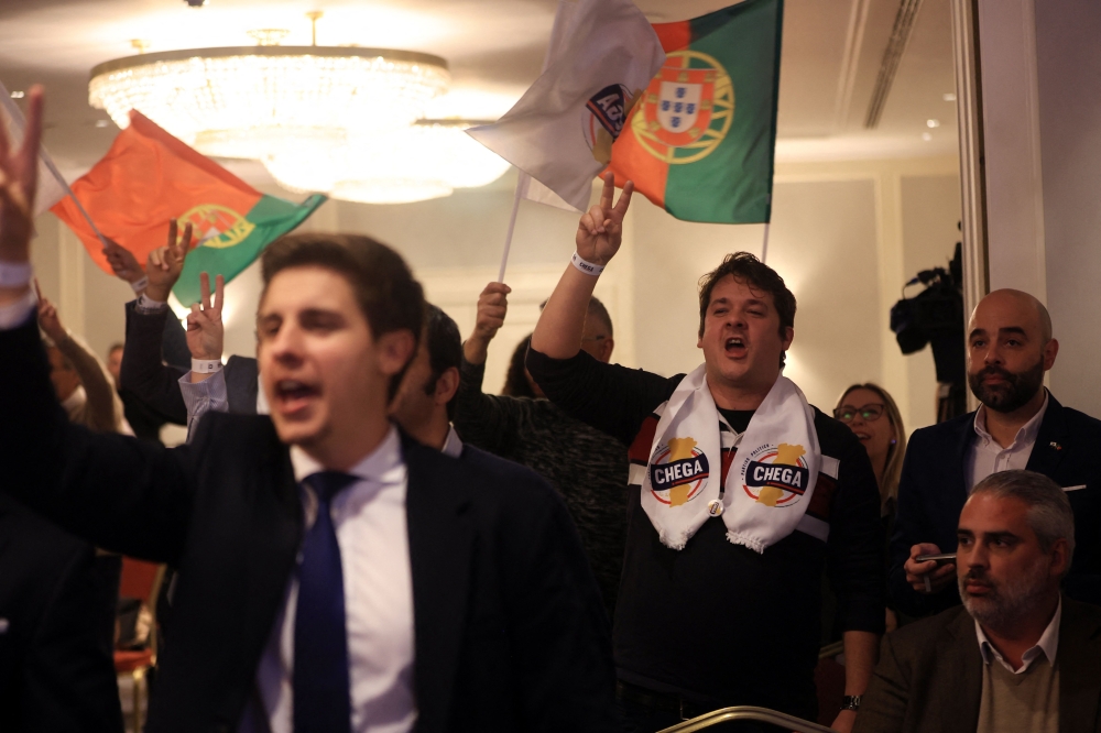 Chega supporters react to partial results showed on TV, at Marriot hotel, the party’s electoral night headquarters, in Lisbon on March 10, 2024. — AFP pic