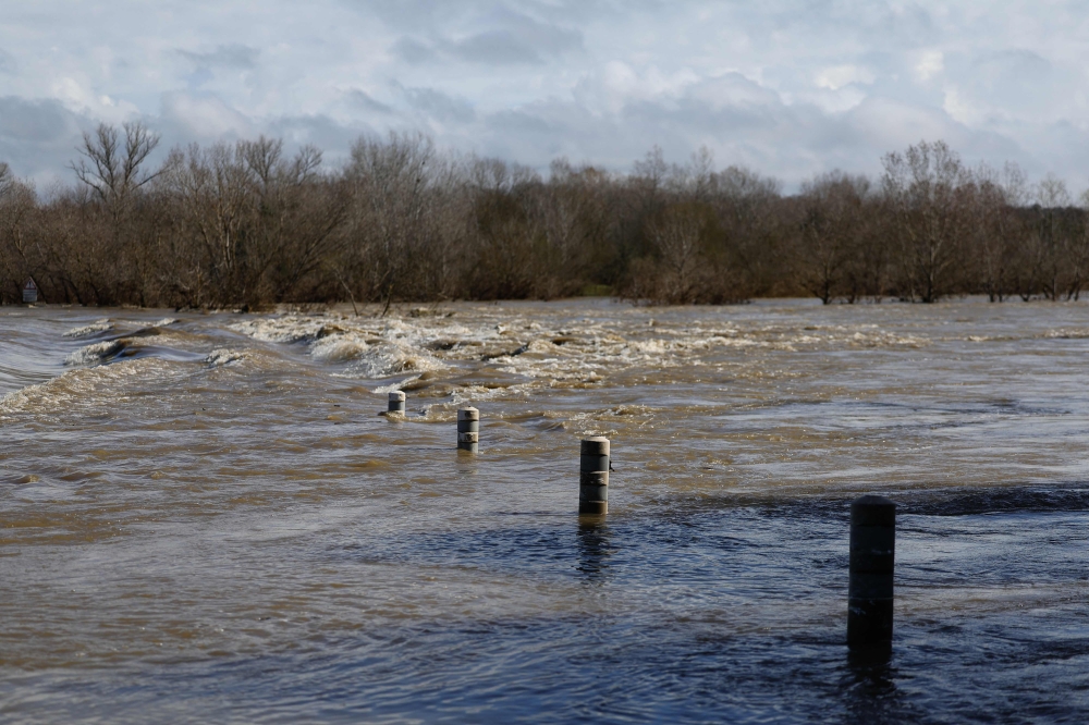 A bridge submerged by the flooded Gard river is pictured in Dions, on March 10, 2024 following heavy rain over south-eastern France. — AFP pic