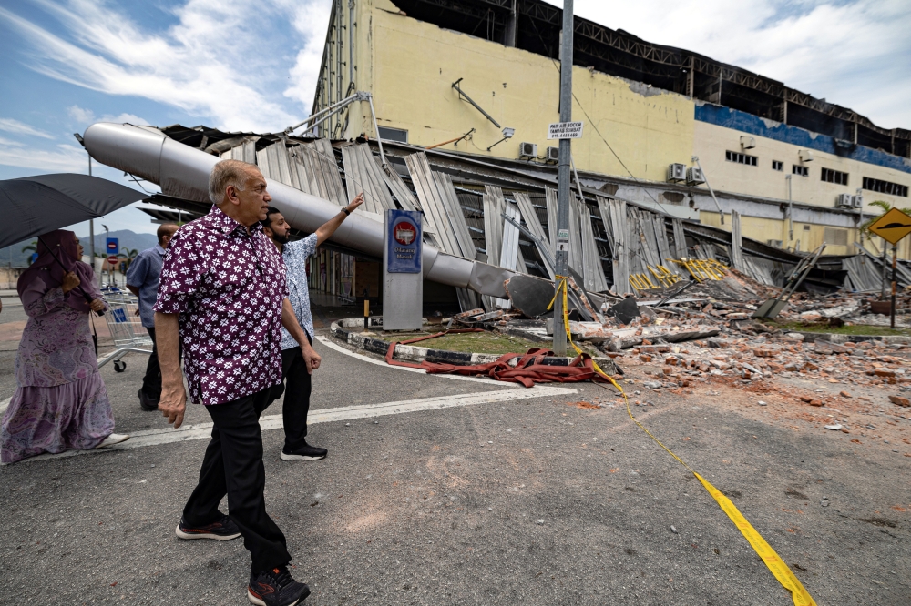 Mydin Mohamed Holdings Berhad managing director Datuk Ameer Ali Mydin surveys the damage from the fire at the Mydin Manjoi hypermarket, Ipoh, March 11, 2024. — Bernama pic 