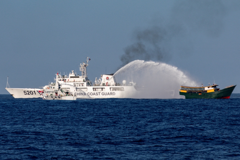 Chinese Coast Guard vessels fire water cannons towards a Philippine resupply vessel Unaizah May 4 on its way to a resupply mission at Second Thomas Shoal in the South China Sea, March 5, 2024. — Reuters pic