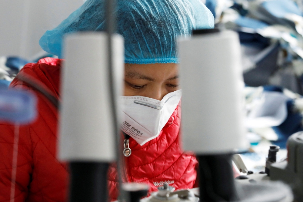 A woman works at a private garment factory in Hanoi January 8, 2021. — Reuters pic  