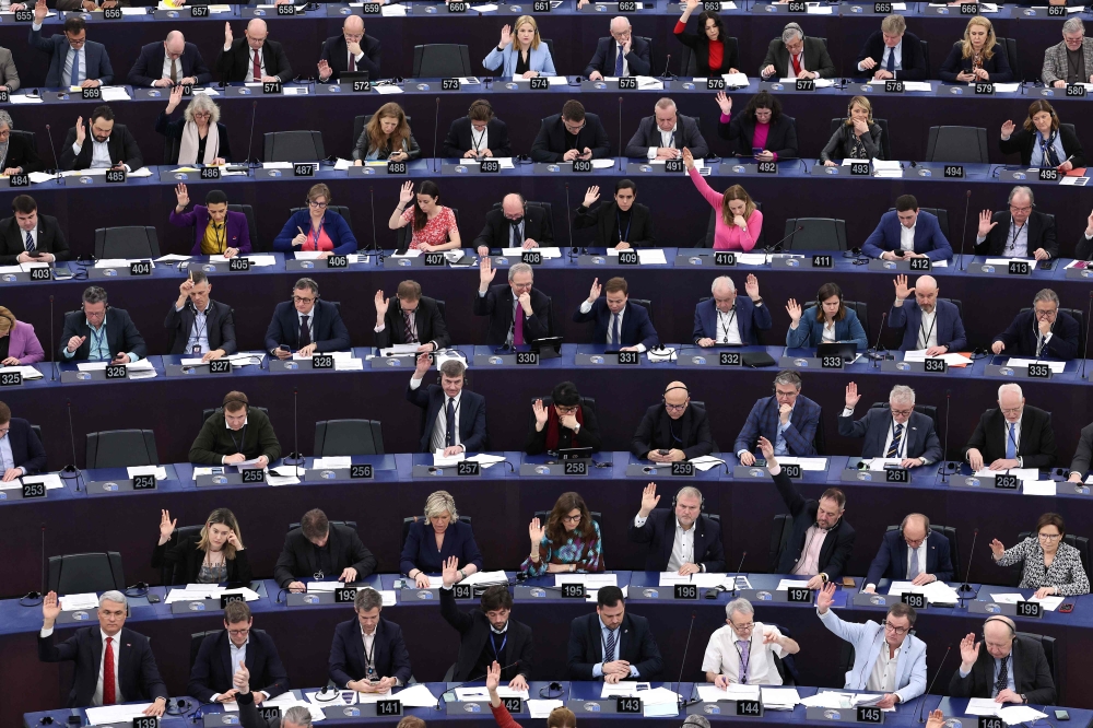 Members of the European Parliament take part in a voting session during a plenary session at the European Parliament in Strasbourg, eastern France, on March 13, 2024. The European Parliament on March 13, 2024 adopted a new EU media freedom law designed to protect journalists from political interference and to improve transparency on media ownership. — AFP pic
