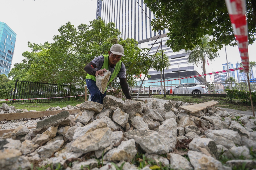 Construction worker Wagiran works on the first day Ramadan in Petaling Jaya on March 12, 2024. Hailing from Padang, Indonesia, he works nine hours a day, six days a week, under the sun. His working hours remain the same regardless of the weather, or whether he is fasting. — Picture by Miera Zulyana