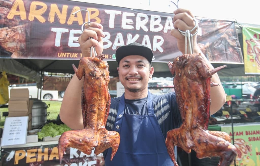 Shahrul's roasted rabbit meat is a hit as he sold 10,000 of the meat during last year's bazaar. — Picture by Farhan Najib