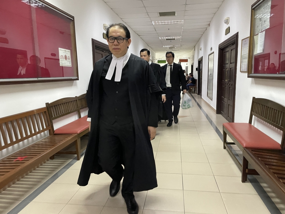 Chong and his legal team are seen at the Kuching Court Complex today. — The Borneo Post pic