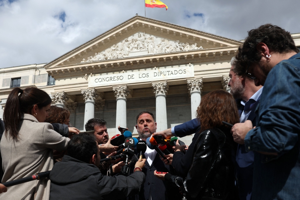 President of Catalan separatist party Esquerra Republicana de Catalunya (ERC) Oriol Junqueras speaks to members of the media after a plenary session at the Spanish parliament's lower house, Congress of Deputies, during which a new amnesty law bill that exonerates figures sentenced or prosecuted for their role in Catalonia's failed 2017 independence bid, was approved, in Madrid on March 14, 2024. — AFP pic