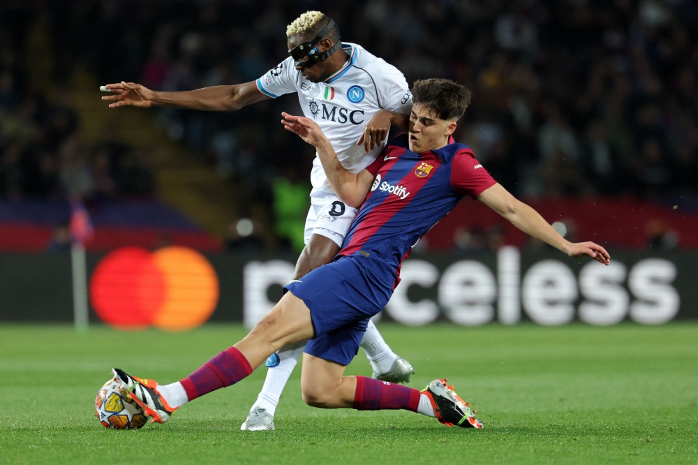 Barcelona’s Spanish defender Pau Cubarsi and Napoli’s Nigerian forward Victor Osimhen vie for the ball during the Uefa Champions League last 16 second leg football match between FC Barcelona and SSC Napoli at the Estadi Olimpic Lluis Companys in Barcelona on March 12, 2024. — AFP pic 