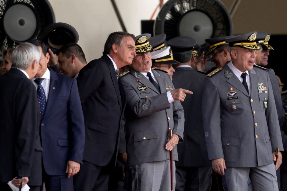 File photo of Brazil’s President Jair Bolsonaro speaking with Army Commander Marco Antonio Freire Gomes as they attend a graduation ceremony at the Agulhas Negras Military Academy in Resende, Rio de Janeiro, Brazil November 26, 2022. — Reuters pic