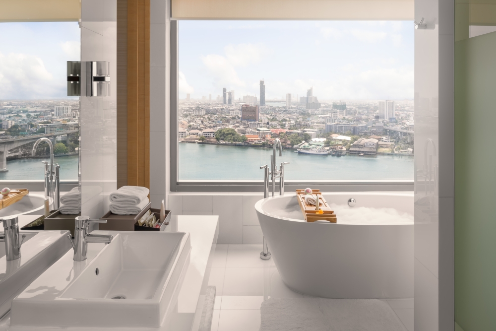 Each of the River View Junior Suites features a bathroom with a view, outfitted with freestanding tub. — Picture courtesy of Avani  Riverside Bangkok Hotel
