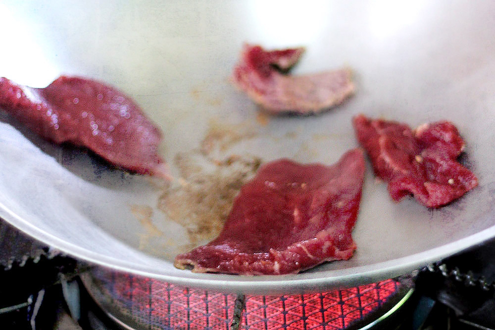 Dry-frying the beef helps sear the meat and retain its juices.