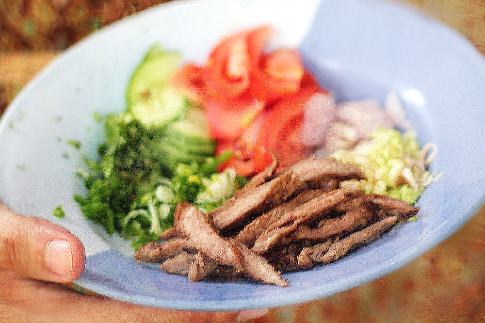 The colourful ingredients are carefully arranged before being tossed in the dressing.