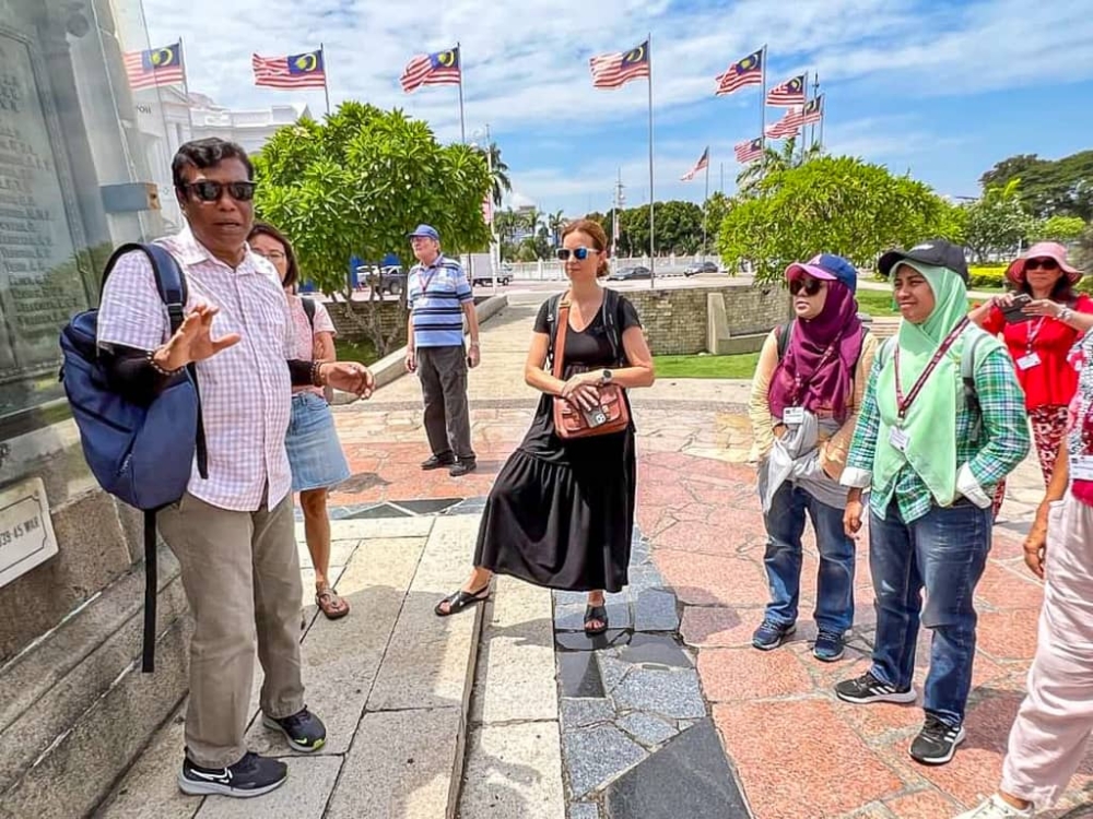 Sundralingam need not travel far to 'see' the world as he gets tourists of all nationalities in the course of his work. — Picture courtesy of S. Sundralingam