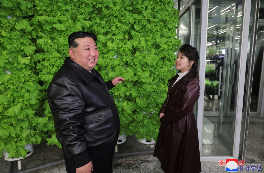 This picture taken on March 15, 2024 and released from North Korea’s official Korean Central News Agency (KCNA) on March 16 shows North Korean leader Kim Jong Un (left) and his daughter Ju Ae (2nd right) visiting the Gangdong Comprehensive Greenhouse in Pyongyang. — AFP pic