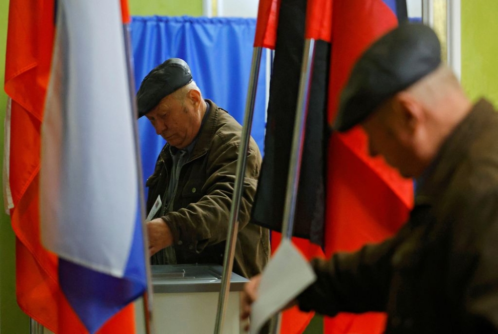 A man casts his ballot at a polling station during the Russia's presidential election, in the course of Russia-Ukraine conflict in Donetsk, Russian-controlled Ukraine, March 16, 2024. — Reuters pic