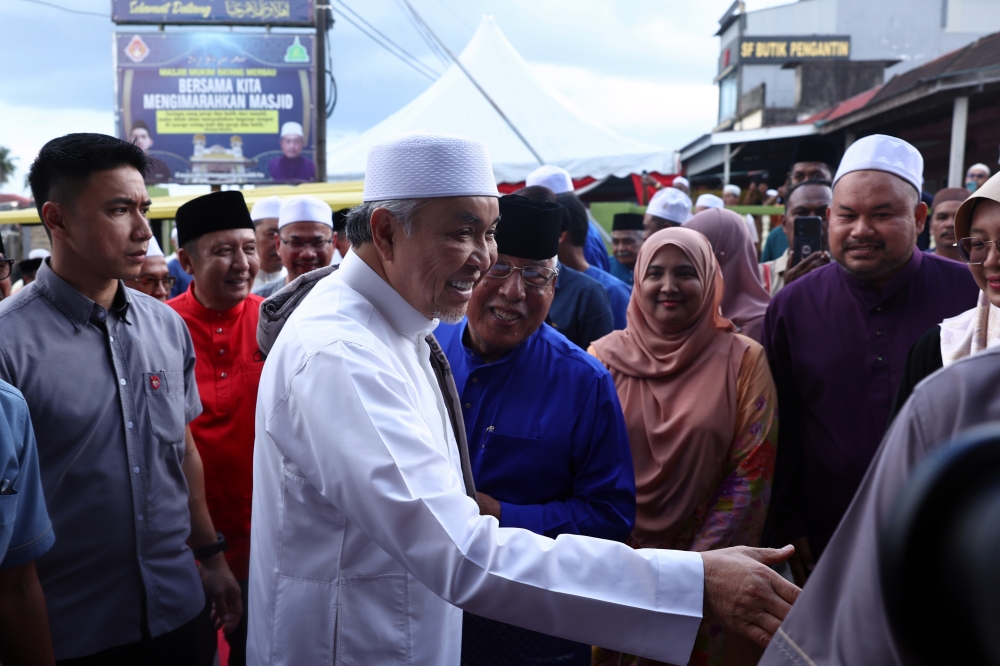Deputy Prime Minister Datuk Seri Dr Ahmad Zahid Hamidi meeting the local people when he attends the Ramadan Charity Ceremony at the Batang Merbau Mosque in Tanah Merah, March 16, 2024. — Bernama pic