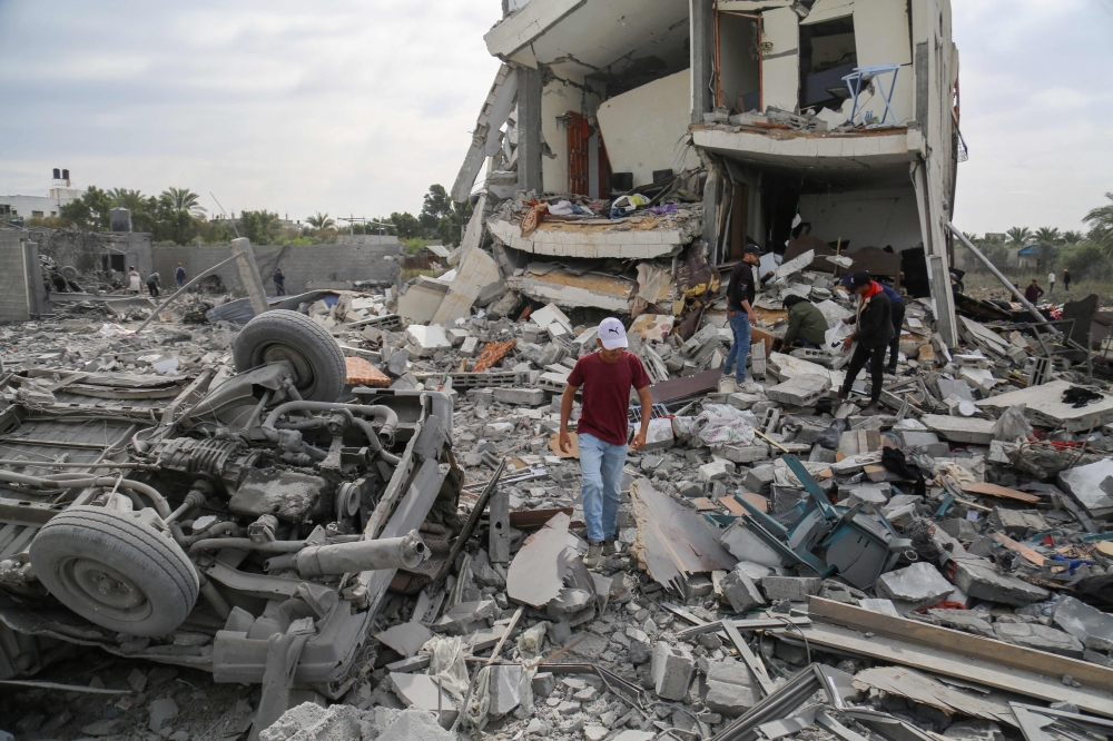 Palestinians search the rubble of the Tabatibi family home following overnight Israeli bombardment west of the Nuseirat refugee camp in the central Gaza Strip on March 16, 2024. — AFP pic
