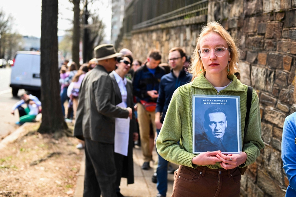 Russian citizens queue outside the Russian embassy to cast their votes in Washington on March 17, 2024. — AFP pic