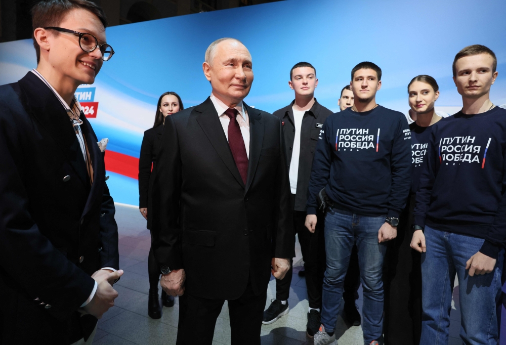 Russian President Vladimir Putin meets with his confidants and volunteers of his campaign headquarters in Moscow on March 17, 2024. — AFP pic