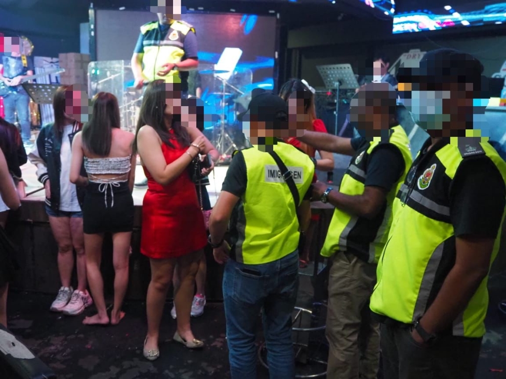 Johor Immigration Department enforcement officers during a raid at an entertainment centre in Iskandar Puteri where 44 foreigners were nabbed last weekend.  —  Picture courtesy of Johor Immigration Department 