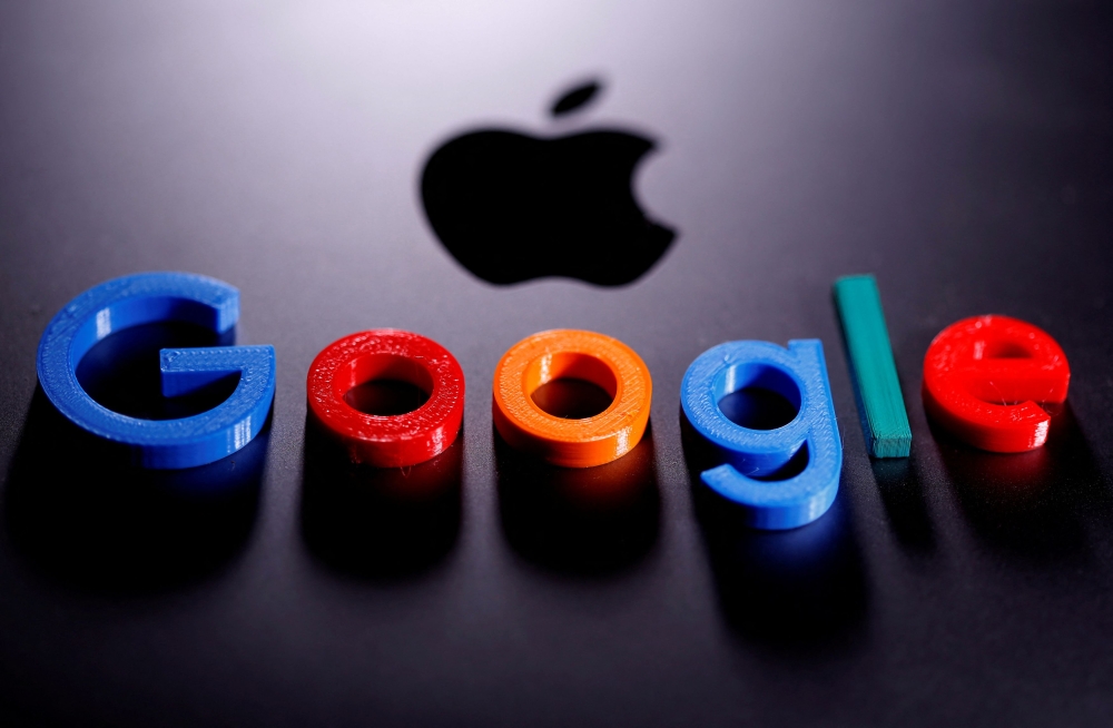 A 3D printed Google logo is placed on the Apple Macbook in this illustration taken April 12, 2020. — Reuters file pic