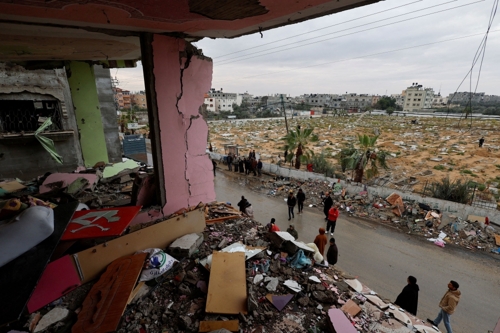 Palestinians inspect the site of an Israeli strike on a house, amid the ongoing conflict between Israel and Hamas, in Rafah, in the southern Gaza Strip, March 19, 2024. — Reuters pic