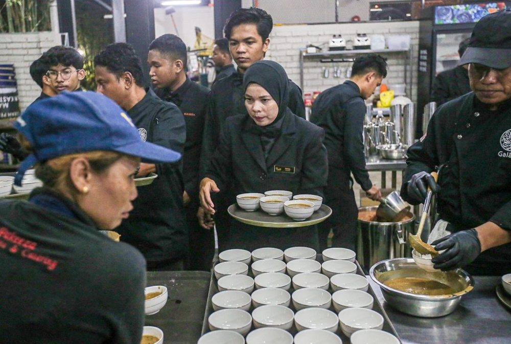 With many dishes to prepare in the kitchen, busy workers and banquet wait staff have to delayed their own breaking of the fast.