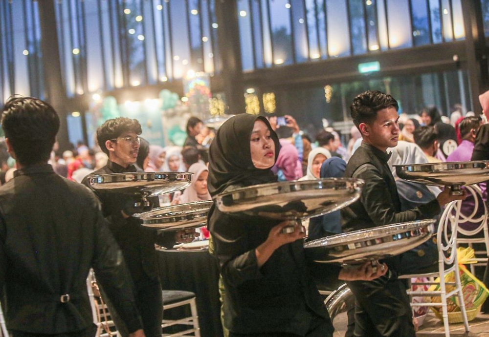 The waiters making an impressive entrance with the first course.