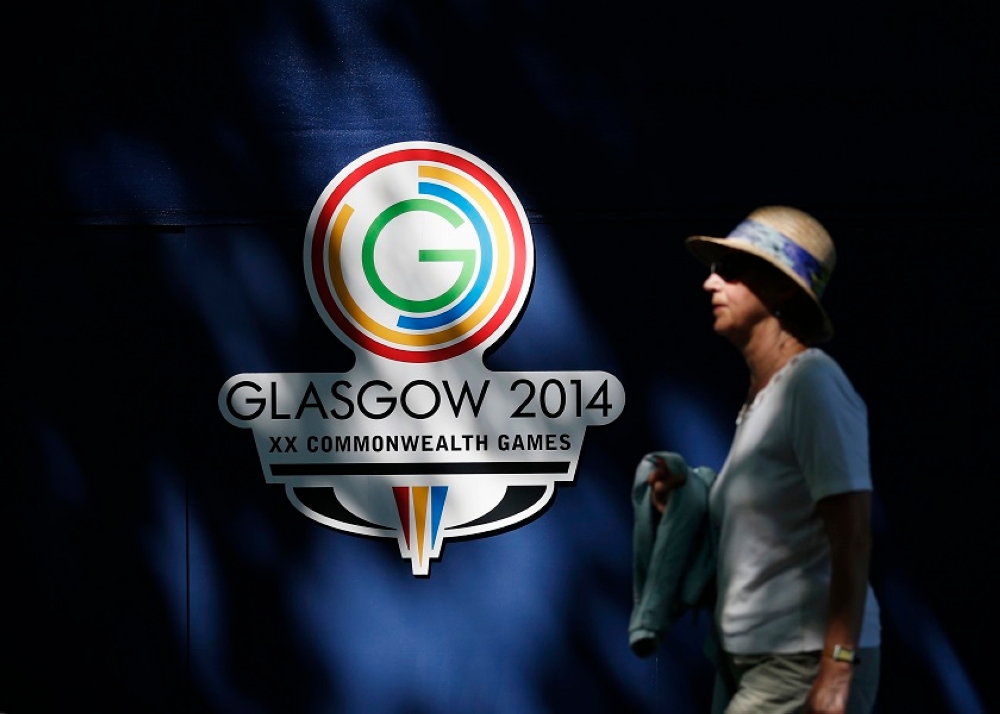 A spectator walks past the Commonwealth Games logo at the Kelvingrove Lawn Bowls Centre in Glasgow July 24, 2014. — Reuters pic