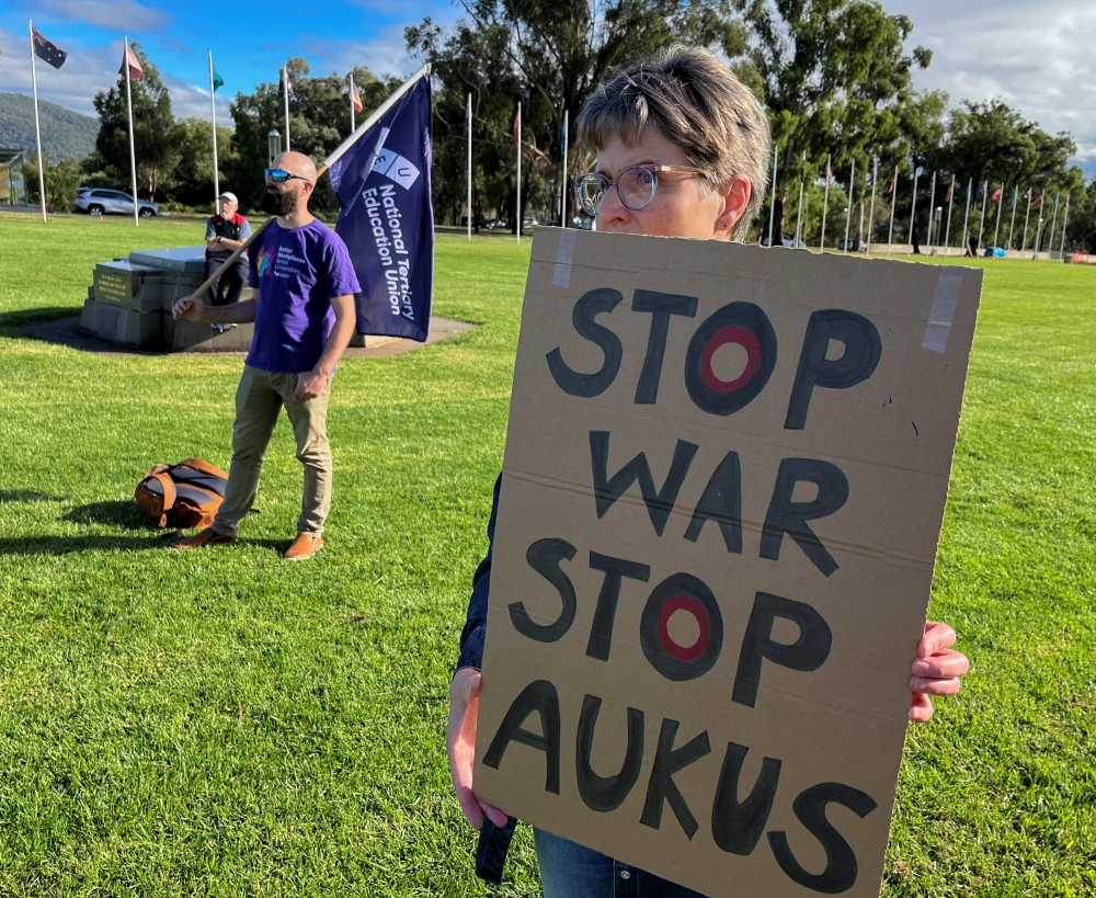 Anti-Aukus protesters stand outside Australia’s parliament, in Canberra on March 18, 2024. — Reuters pic