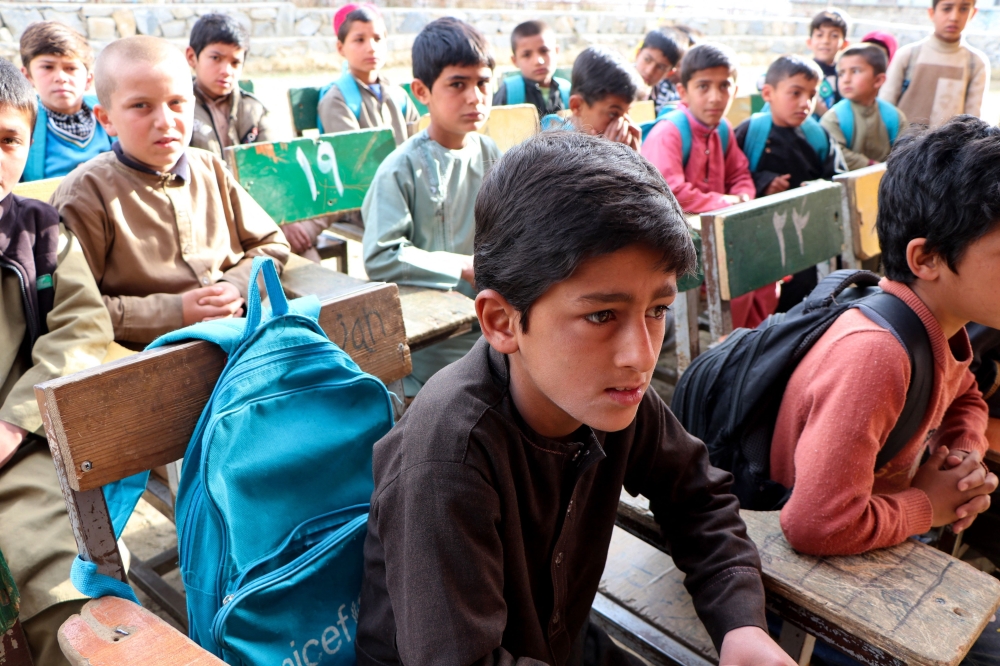 Afghan school boys attend their first class following the start of the new academic year, at a school in Charikar city of Parwan province on March 20, 2024. — AFP pic