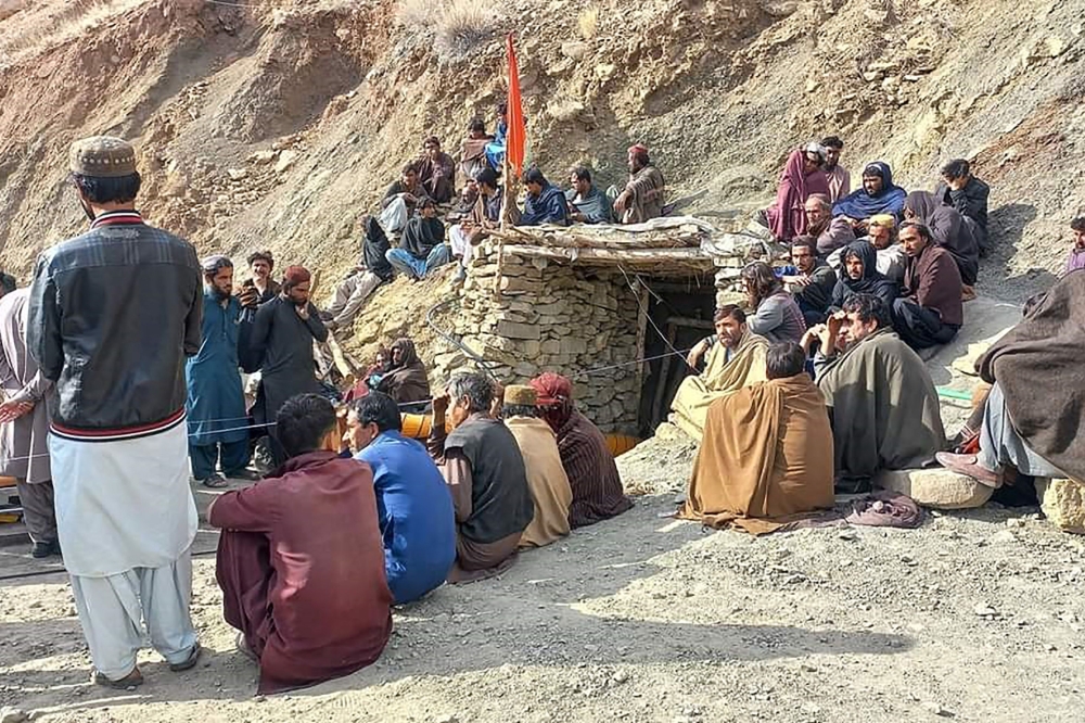 Miners gathered outside a collapsed mine as rescue personnel conduct a search operation for trapped workers after a gas explosion rocked the private coal pit in the mining region of Khost at Harnai district, Balochistan province. — AFP pic/Mines and Minerals Development Department Balochistan