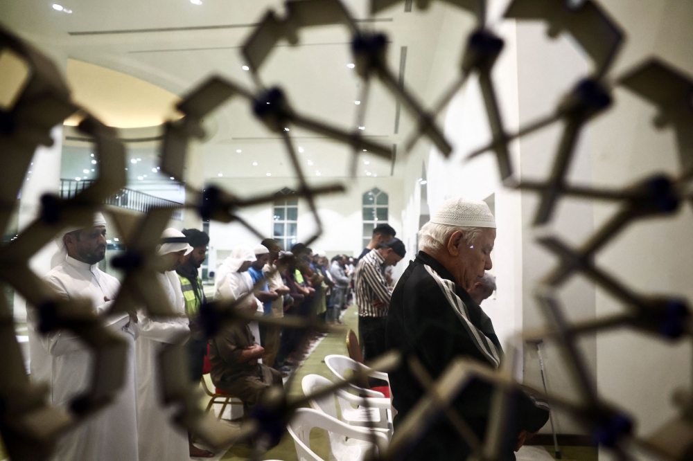 Muslims including Palestinian men evacuees from Gaza perform Taraweeh prayers, during the Muslim holy month of Ramadan at Emirates Humanitarian City, in Abu Dhabi, United Arab Emirates, March 19, 2024. — Reuters pic