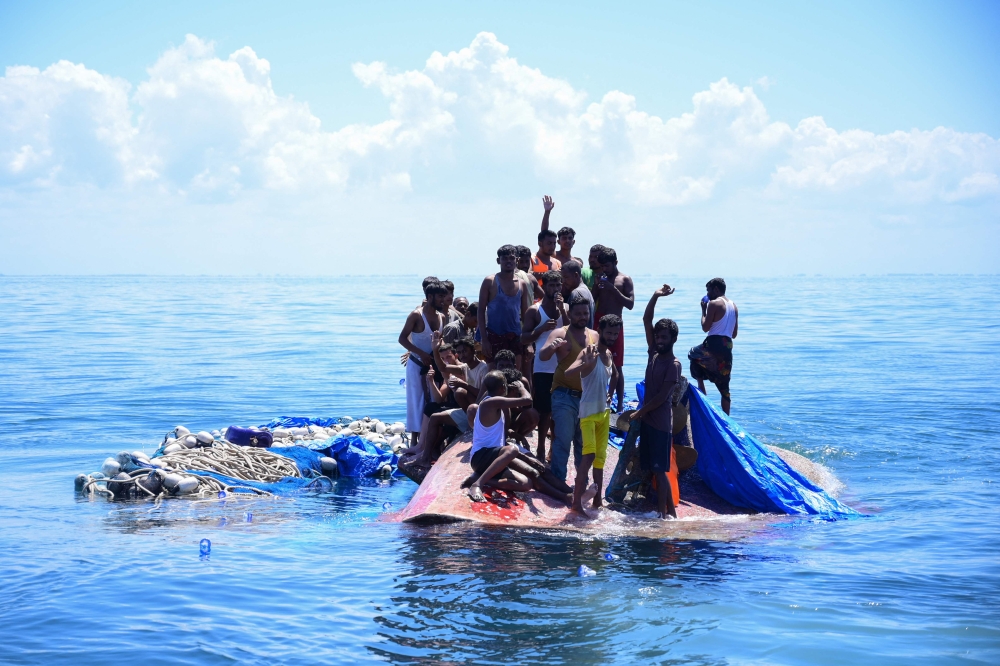 Indonesian authorities rescued at least 69 Rohingya refugees today and were taking them to shore after their boat capsized a day earlier, according to an AFP journalist aboard the rescue vessel. — AFP pic