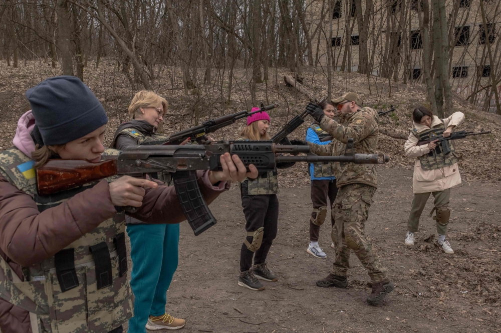 Ukrainian civilian women practice with weapons as they attend training for women focused on the use of weapons and combat medical kit, in Kyiv. — AFP pic