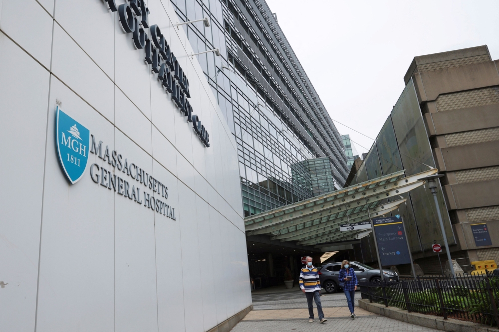People walk past a sign at the entrance to Massachusetts General Hospital in Boston, Massachusetts May 19, 2022. — Reuters pic