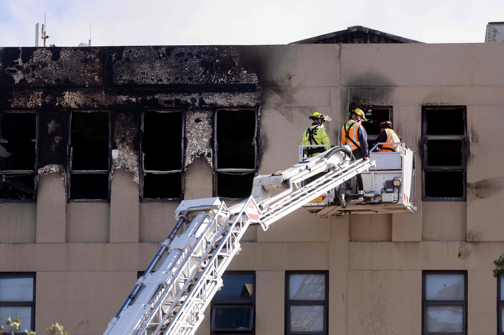 The blaze last May engulfed the four-storey, 92-room Loafers Lodge hostel in Wellington city centre, causing such extensive damage that it took police two weeks to examine the building. — AFP pic