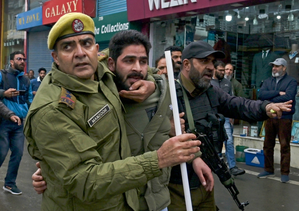 Police detains a supporter of Aam Aadmi Party (AAP) at a protest in Srinagar on March 22, 2024. — AFP pic 