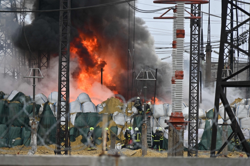 Firefighters extinguish a fire at an electrical substation after a missile attack in Kharkiv, on March 22, 2024, amid the Russian invasion in Ukraine. — AFP pic 