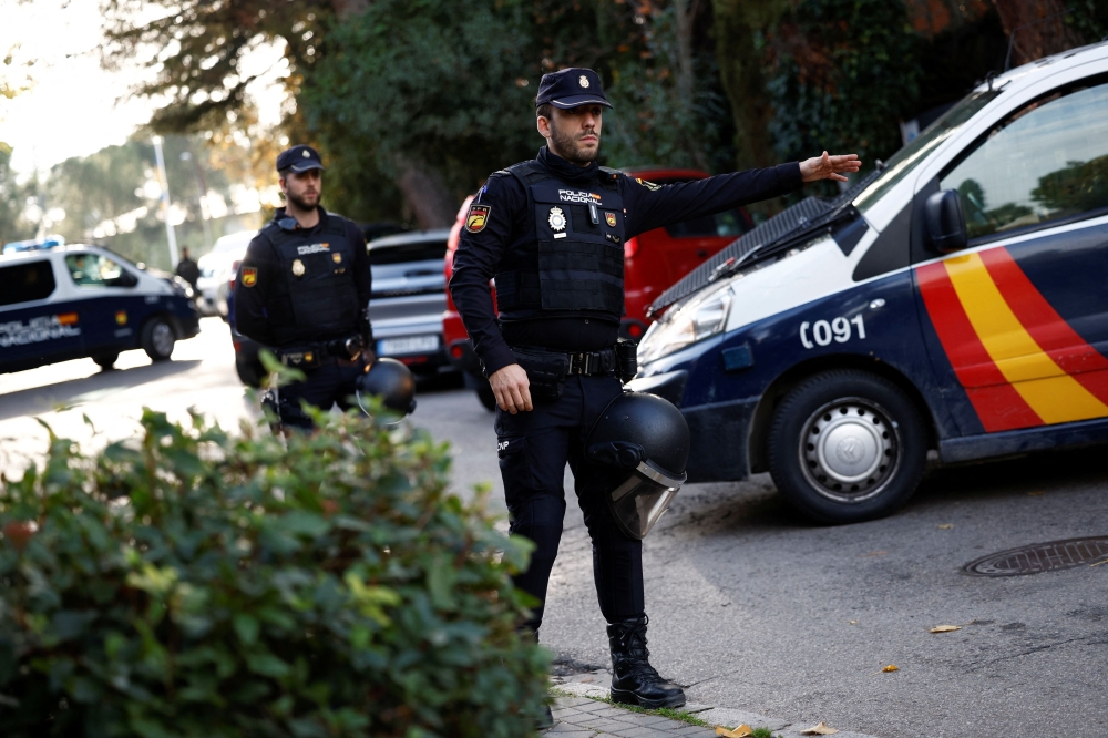 FIle picture of Spanish police officers in Madrid. Spanish police said today they had broken up a gang specialising in night-time helicopter flights to bring in hashish from Morocco, during a joint operation with their Moroccan counterparts. — Reuters pic