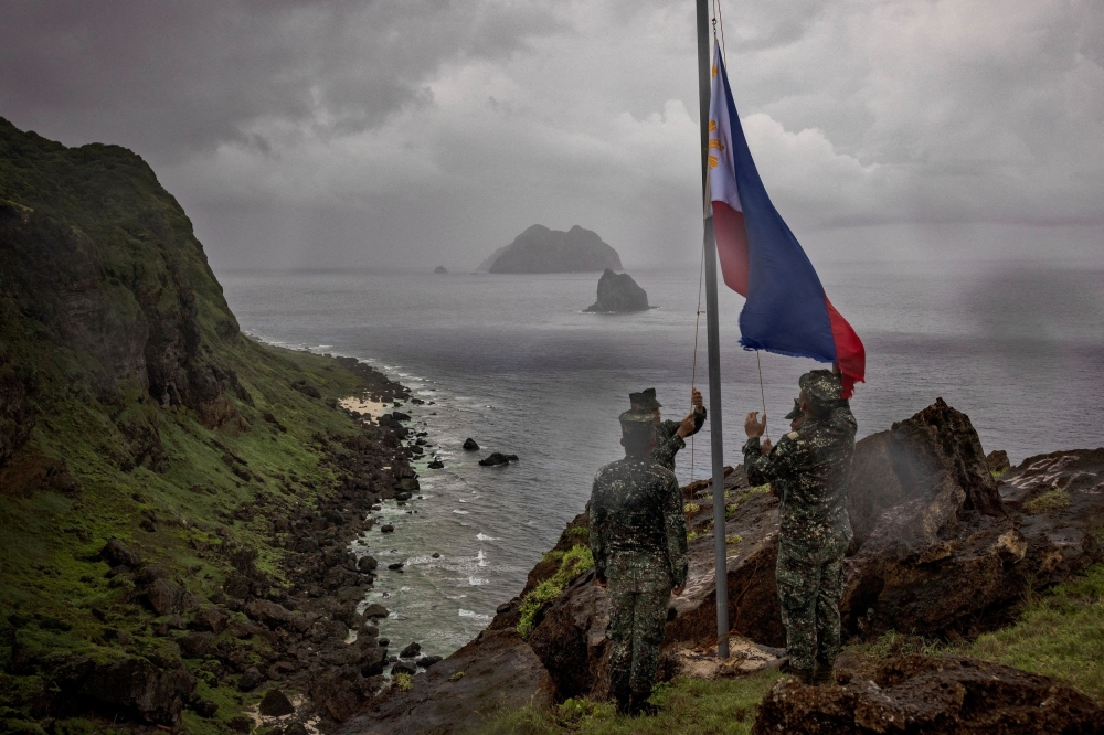 Filipino soldiers take part in a flag raising ceremony on Mavulis Island during a trip of the chief of staff of the Armed Forces of the Philippines, in Batanes, Philippines, June 29, 2023. Batanes, a group of idyllic islands at the country’s northernmost tip, lies just 140 kilometers from Taiwan. — Ezra Acayan/Pool/Reuters pic